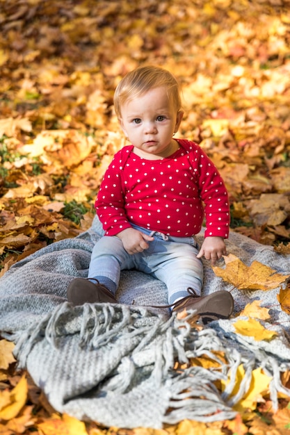 Free photo full shot cute baby on blanket outdoors