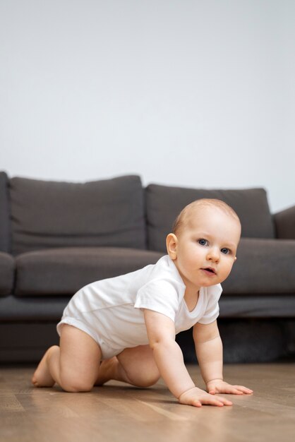 full shot cute baby on floor