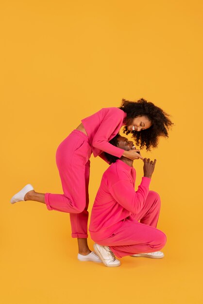 Full shot cute couple posing together in studio