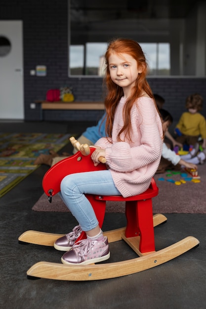 Full shot cute girl at kindergarten