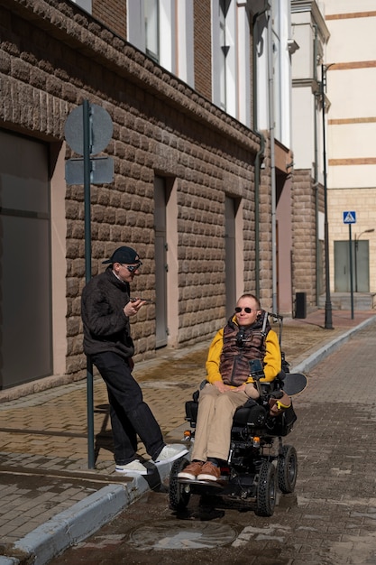 Full shot disabled man and friend spending time together
