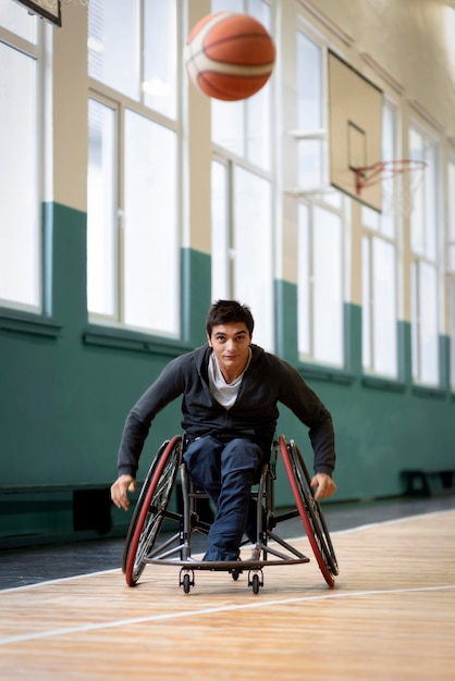 Full shot disabled man going after ball