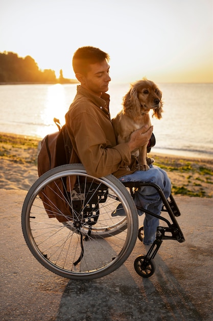 Full shot disabled man holding dog