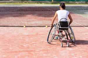 Free photo full shot disabled woman playing tennis