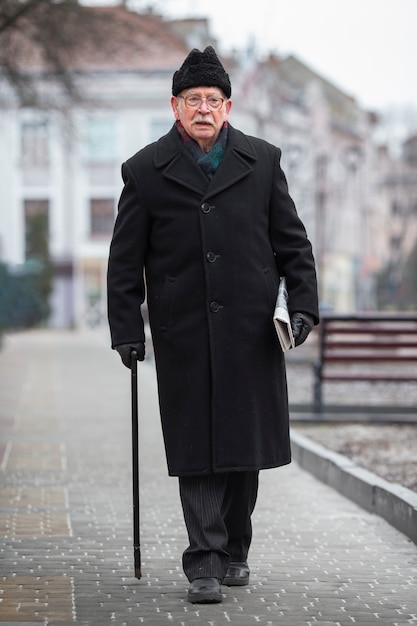 Full shot elderly man taking a stroll