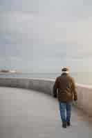 Free photo full shot elderly man taking a stroll