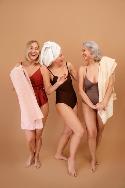 full shot eldery women in swimsuits posing