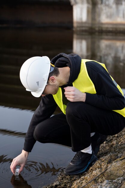 Full shot engineer taking water sample