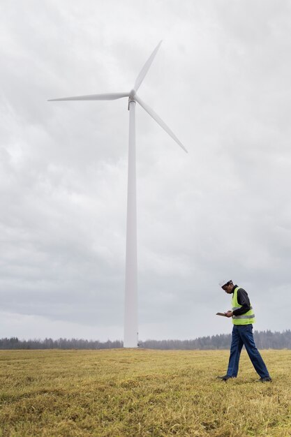 full shot engineer wearing safety helmet outdoors