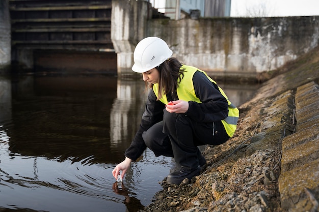 Free photo full shot environmental engineer getting water sample