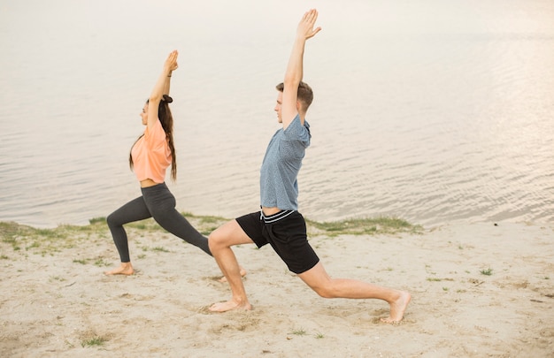 Full shot exercising on the beach