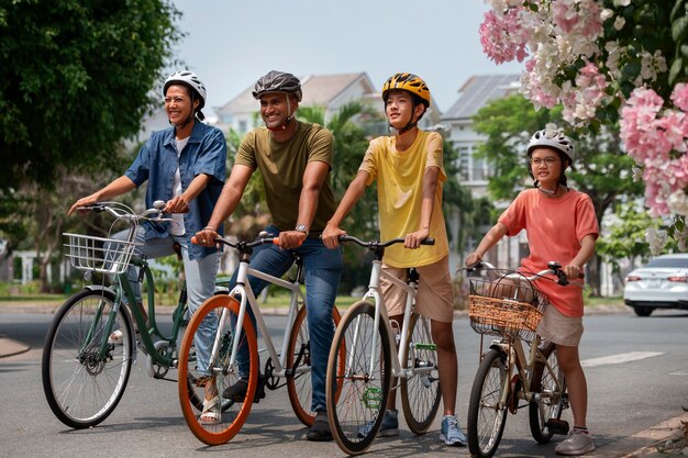 Full shot family cycling outdoors