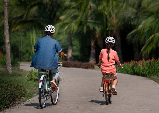 Free photo full shot family cycling outdoors