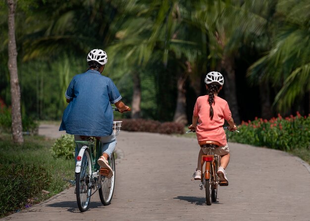 Full shot family cycling outdoors