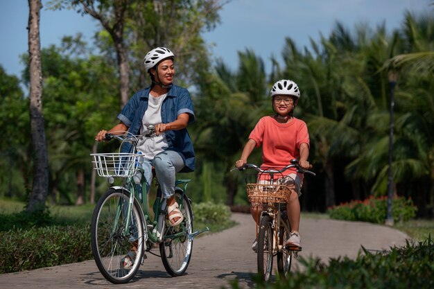 Full shot family cycling outdoors