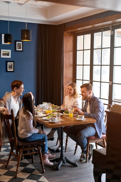 Full shot family eating together