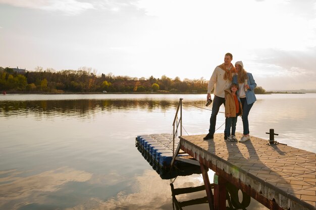 Full shot family hanging out on a jetty