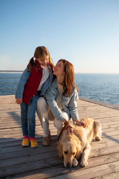 Full shot family hanging out on a jetty