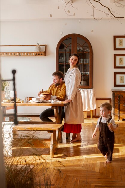 Full shot family living at farmhouse