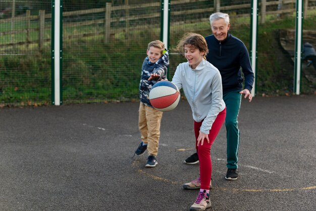 Full shot family members playing basketball