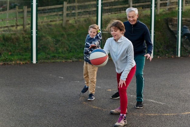 Full shot family members playing basketball