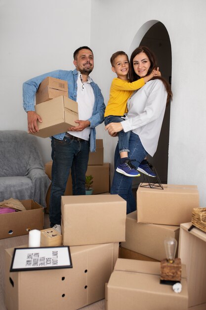 Full shot family ready to move into a new home