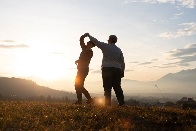 Full shot family silhouette in nature at sunset