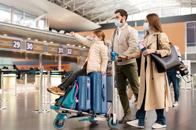 Full shot family wearing face masks