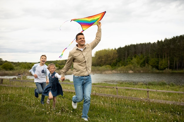 Full shot family with colorful kite