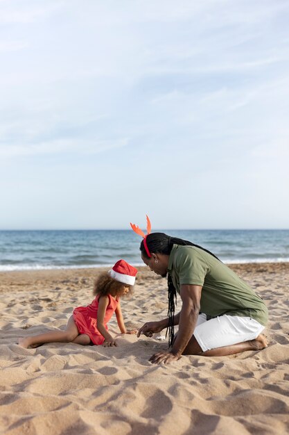 Full shot father and girl at beach