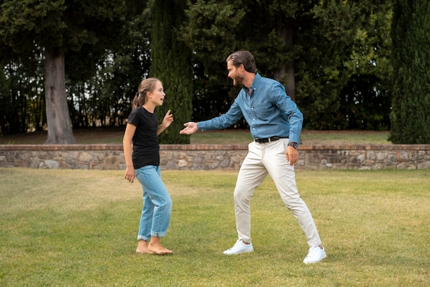 Full shot father and girl in nature