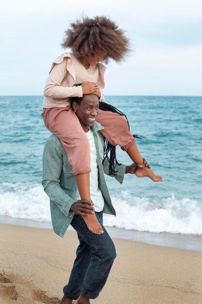 Free photo full shot father holding smiley kid