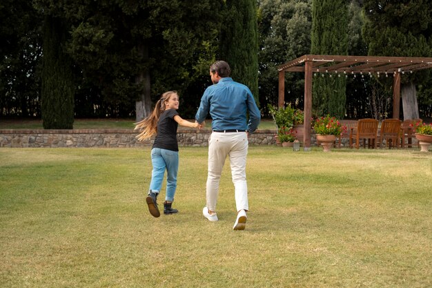 Full shot father and kid running