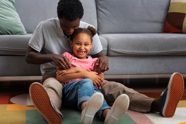 Free photo full shot father tickling girl