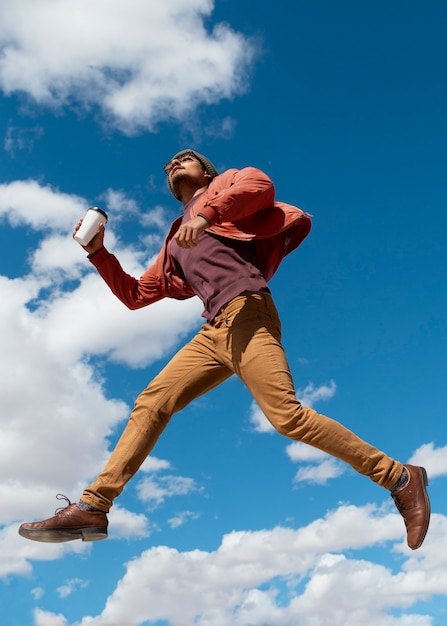 Full shot fit man jumping outdoors