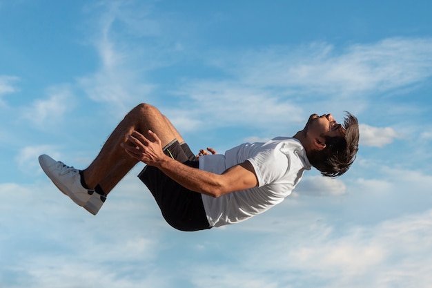 Full shot fit man jumping outdoors