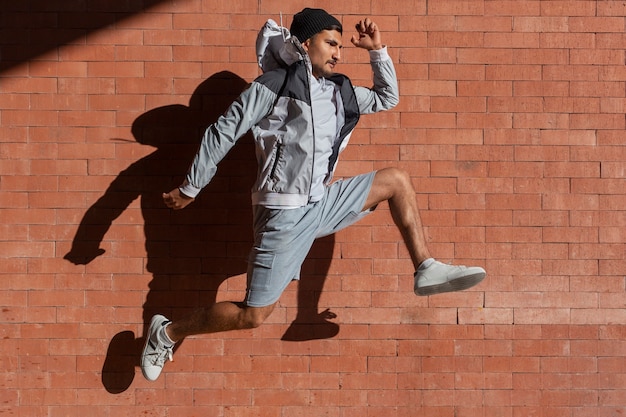 Full shot fit man jumping outdoors