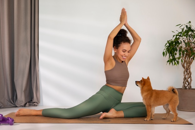 Full shot fit woman doing sport with dog