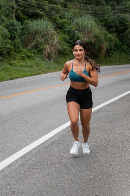 Full shot fit woman running outdoors