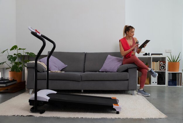 Full shot fit woman with treadmill