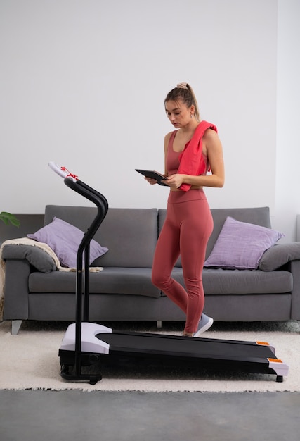 Full shot fit woman with treadmill