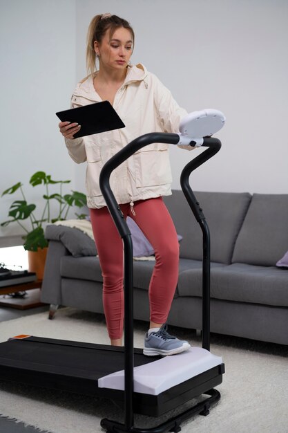 Full shot fit woman with treadmill