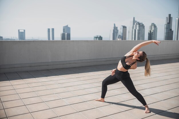 Full shot fit young girl exercising