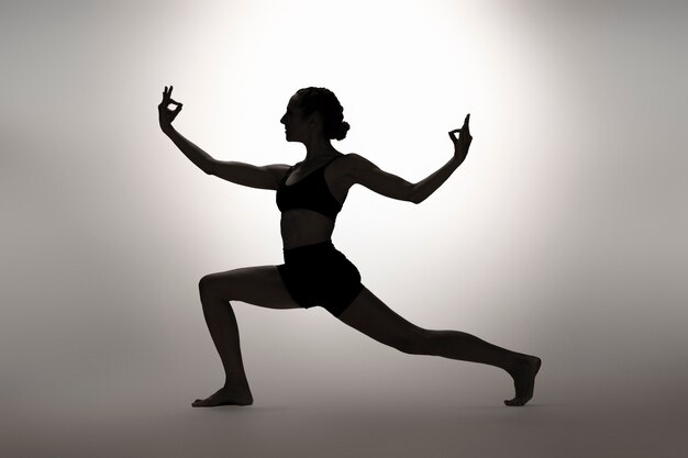 Full shot flexible woman posing  in studio