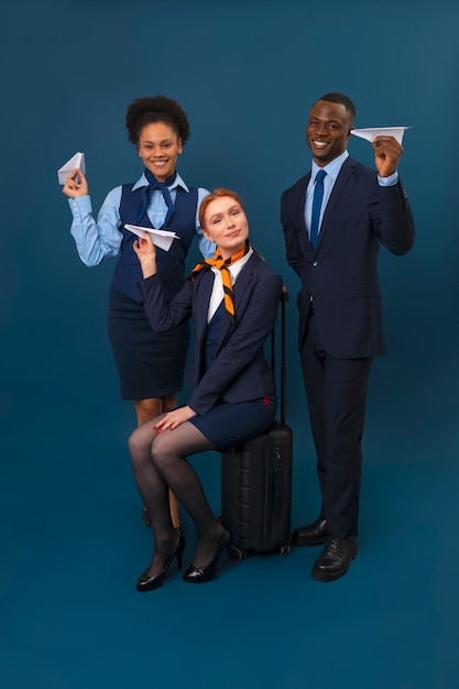 Full shot flight attendants with baggage