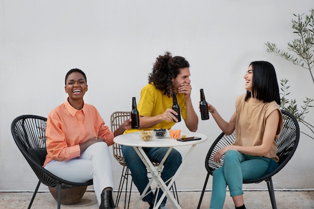 Full shot friends chatting at table