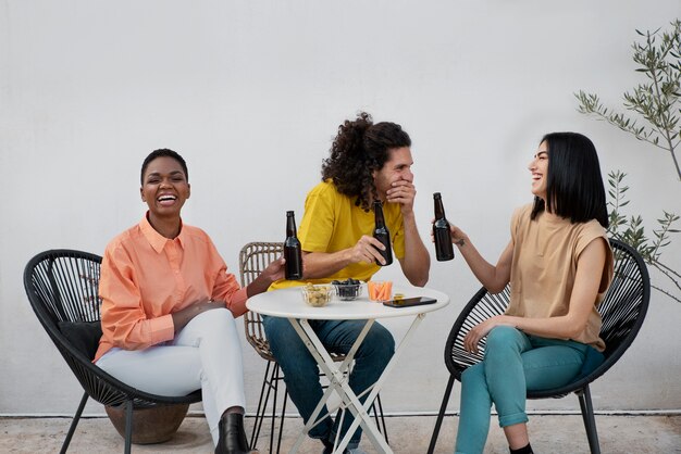 Full shot friends chatting at table