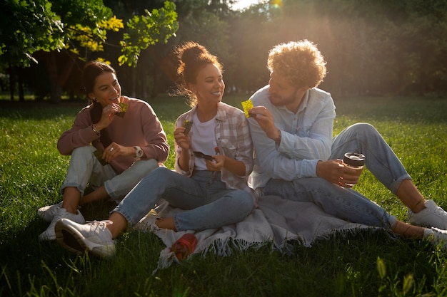 Free photo full shot friends eating seaweed snacks