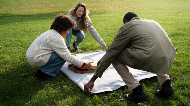 Full shot friends having picnic