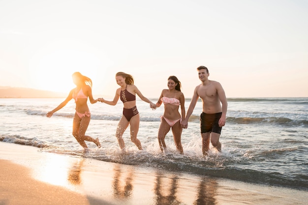 Full shot friends holding hands